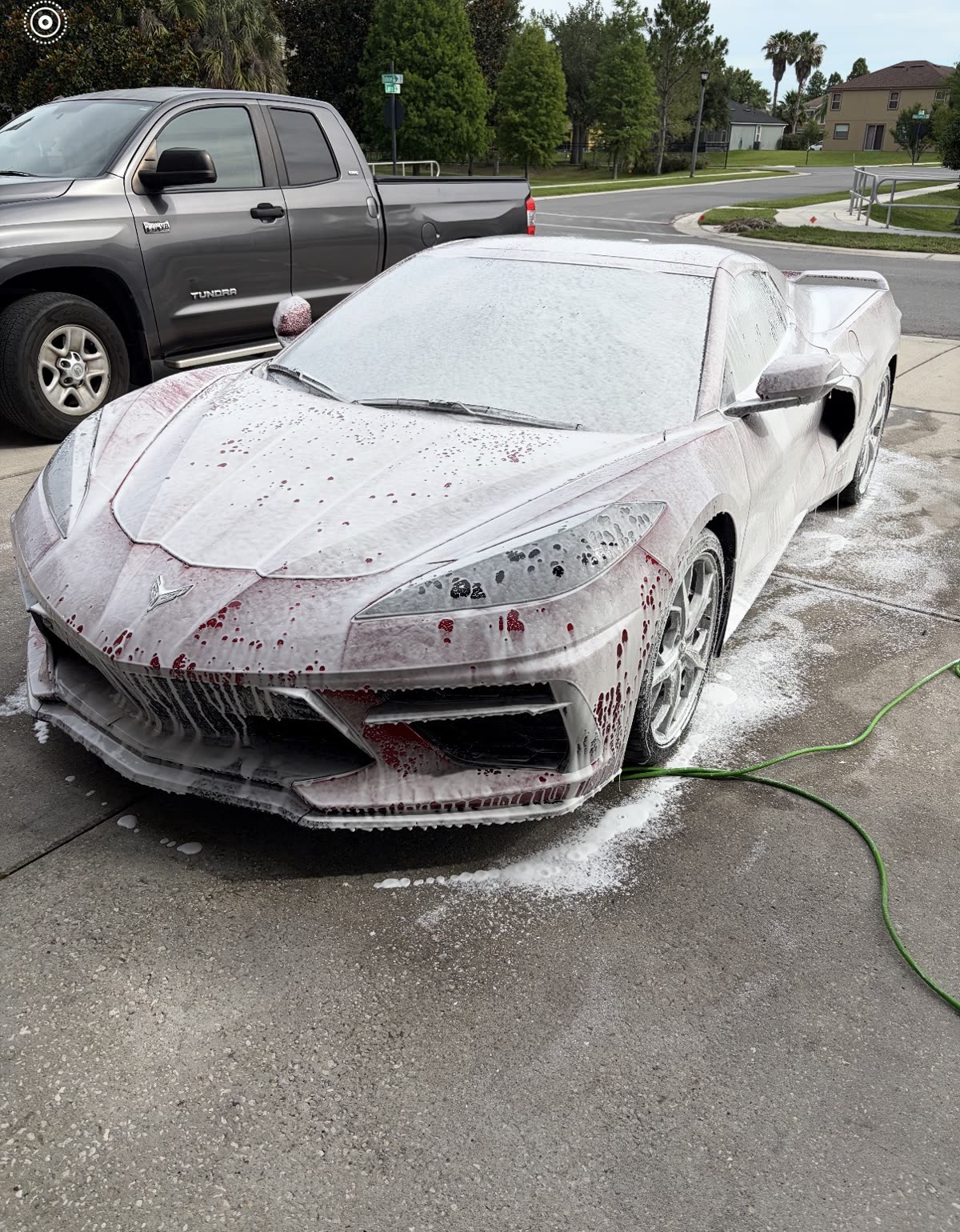 Corvette C8 covered in thick snow foam during a PureVisions pre-wash