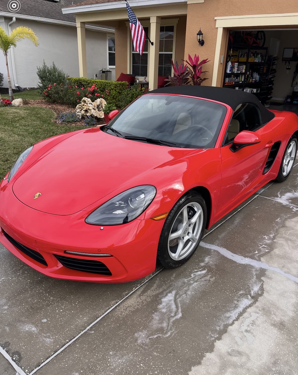 Freshly detailed red Porsche 718 Boxster in a Lakeland driveway
